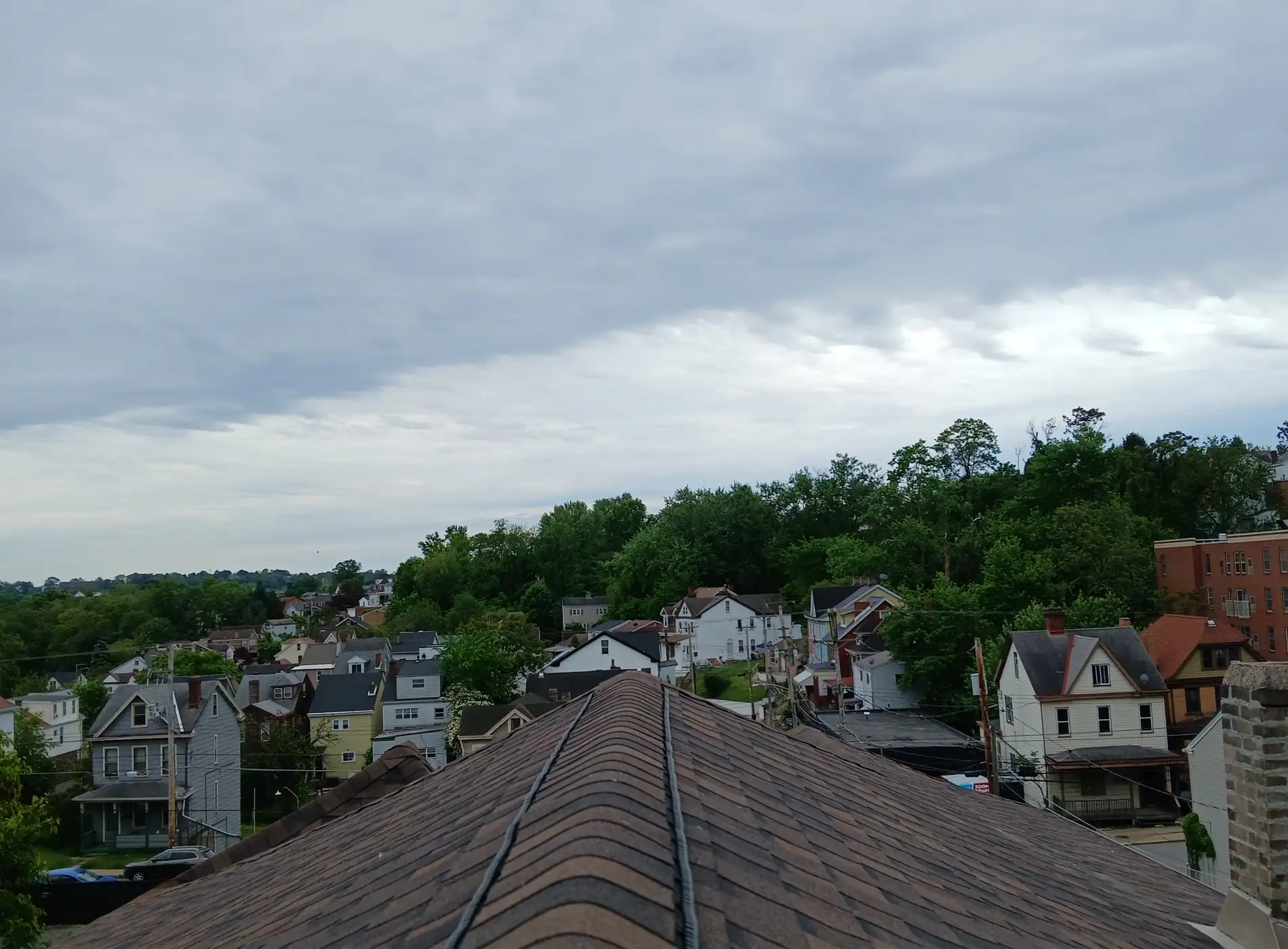 Looking along a finished roof ridge over the rooftops of a Pittsburgh neighbourhood